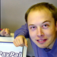 Elon Musk in a file photo from Oct. 20, 2000 posing with the PayPal logo at PayPal’s corporate headquarters in Palo Alto, Calif
